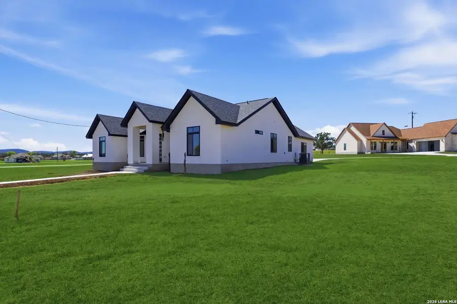 Front exterior of a new home in , Bandera, TX, highlighting curb appeal (Image 25).