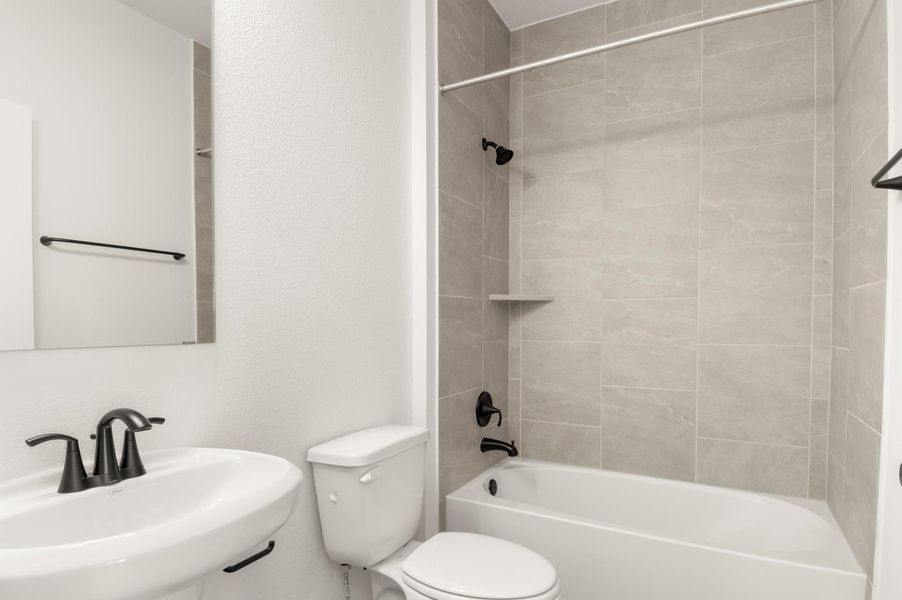 Full bath with bathtub / shower combination and a textured wall Full bath with bathtub / shower combination and a textured wall