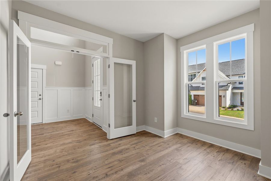 A versatile open space with rich wood flooring and