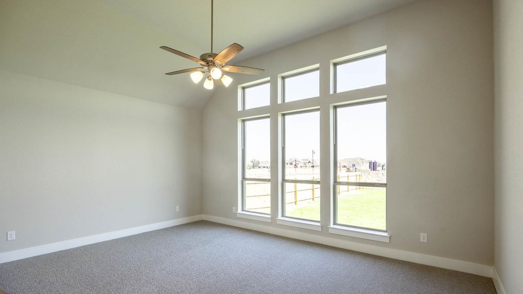 Spare room featuring carpet flooring, ceiling fan, a residential view, and high vaulted ceiling Spare room featuring carpet flooring, ceiling fan, a residential view, and high vaulted ceiling