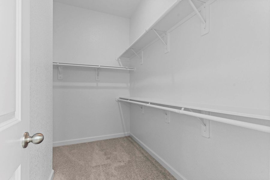 Expansive walk-in closet with abundant hanging space and built-in shelving, offering both style and convenience for effortless organization.  LOOK AT THE LISTING ON DOCUMENTS AND YOU CAN SEE THE FLOOR PLAN FOR MORE INFORMATION OF THIS STUNNING NEW CASTLEROCK COMMUNITIES HOME!