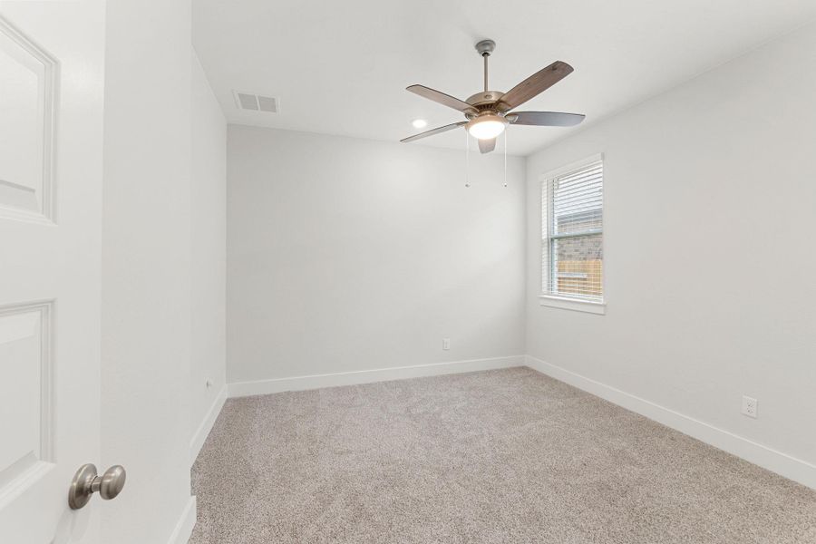 Unfurnished room featuring ceiling fan, carpet, and baseboards Unfurnished room featuring ceiling fan, carpet, and baseboards