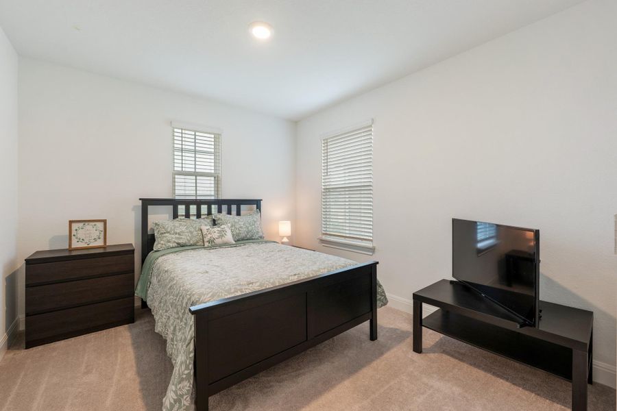 Natural light filters through windows into this comfortable and peaceful sleeping area. Natural light filters through windows into this comfortable and peaceful sleeping area.