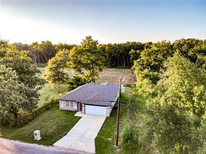 View from above of property featuring a heavily wooded area View from above of property featuring a heavily wooded area