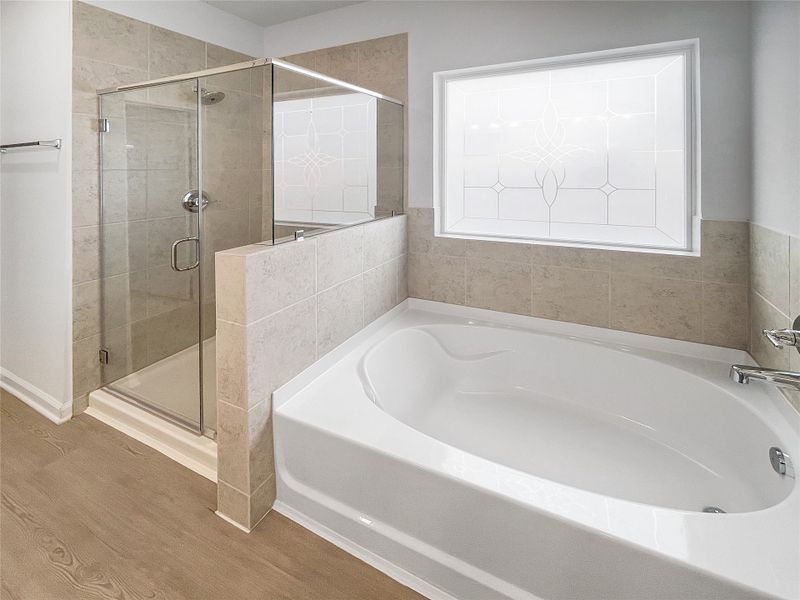 The Waring III- Primary Bathroom with Dual Vanities, Separate Garden tub and Walk-in Shower. Sample image for illustration; upgrades, options, and colors may vary.