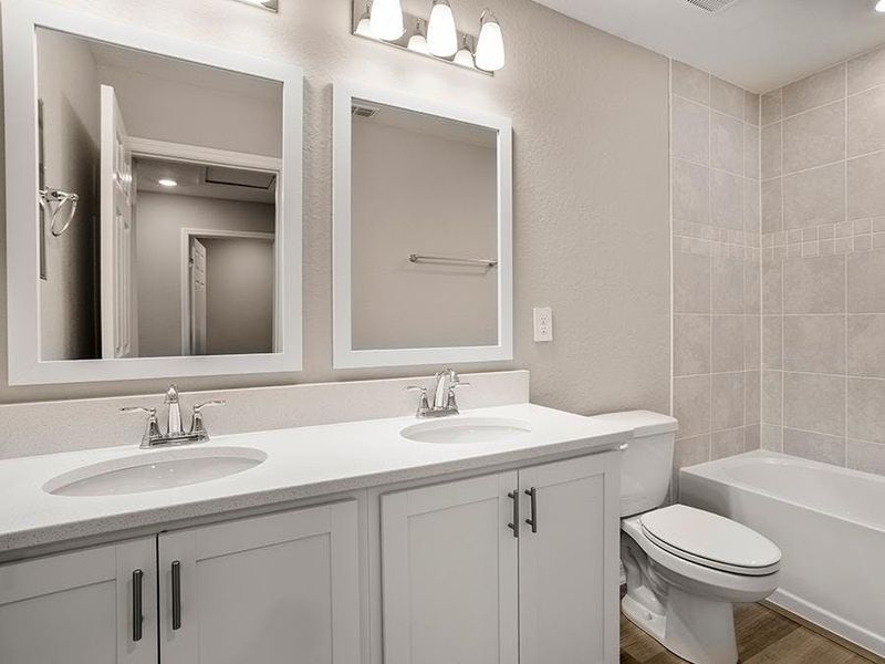 Secondary bedrooms share an upstairs hall bath - Brynn bungalow by Highland Homes