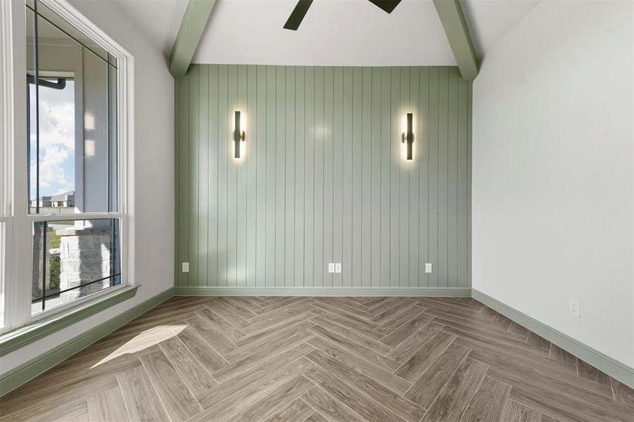 Office with herringbone pattern flooring, a wealth of natural light, wooden walls, and ceiling fan