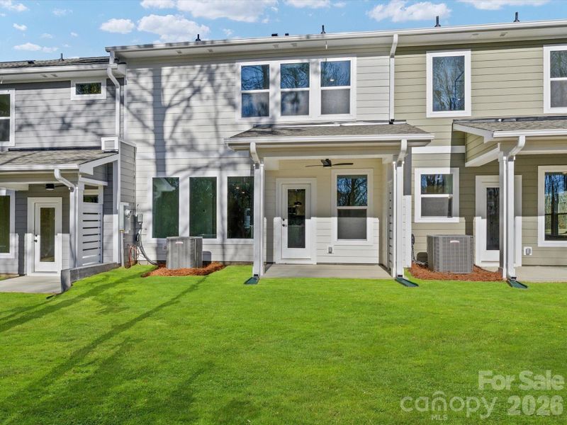 Relax on your covered back porch with views of the woods