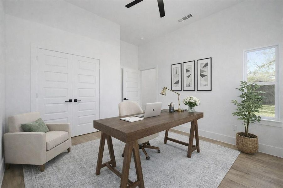 Office space with light wood-type flooring and ceiling fan