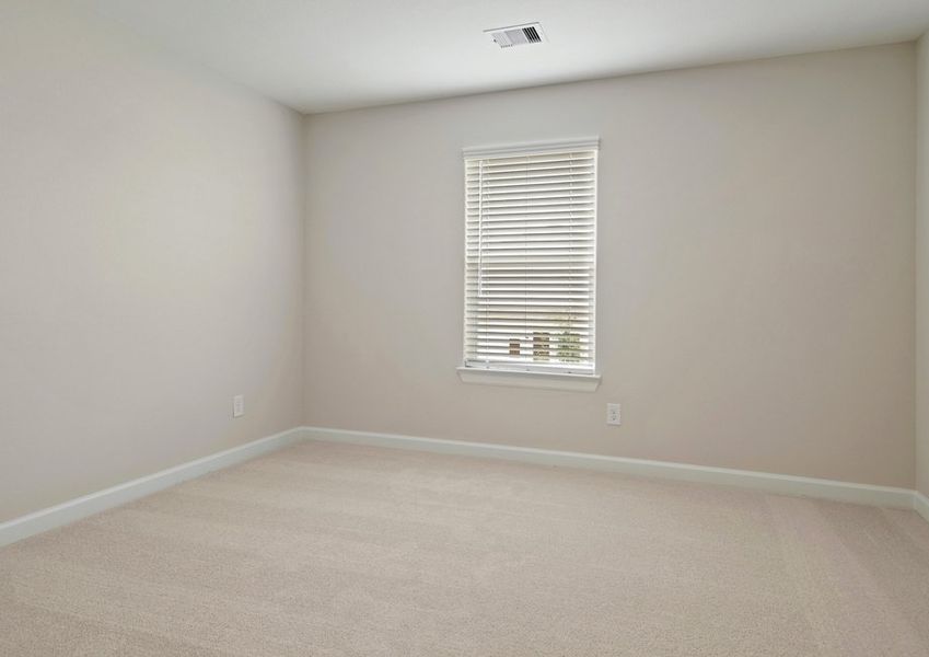 Secondary bedroom with lush carpet