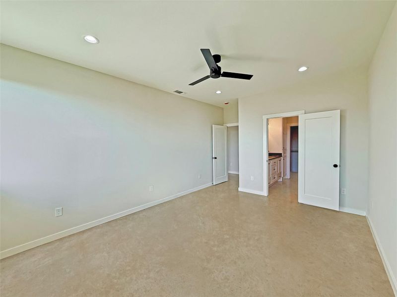 Primary bedroom with recessed lighting, a ceiling fan, and connected bathroom