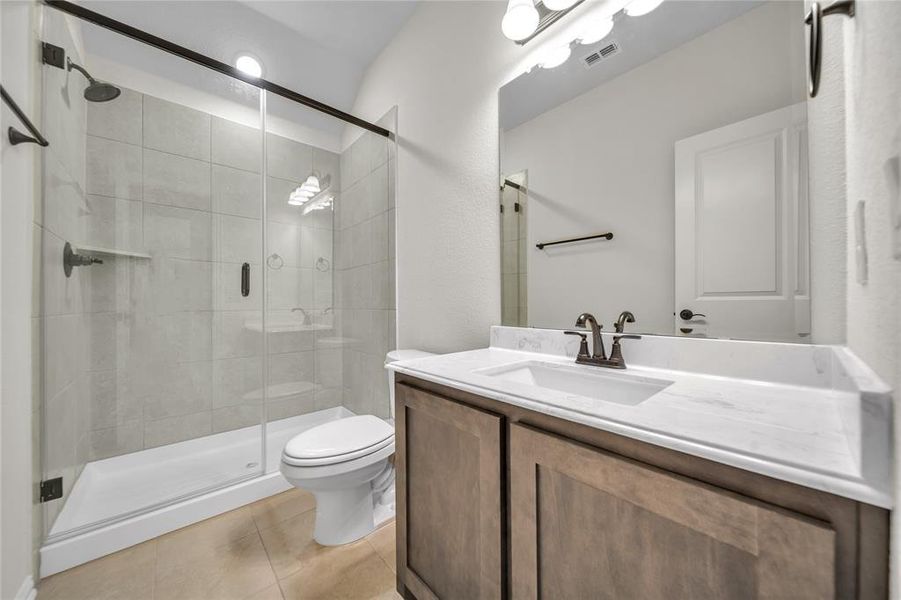 Full bathroom with vanity, a shower stall, and light tile patterned floors Full bathroom with vanity, a shower stall, and light tile patterned floors