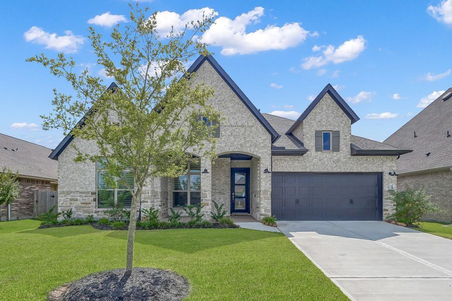 Front exterior of a new home in The Meadows at Imperial Oaks, Conroe, TX, highlighting curb appeal (Image 17). Front exterior of a new home in The Meadows at Imperial Oaks, Conroe, TX, highlighting curb appeal (Image 17).