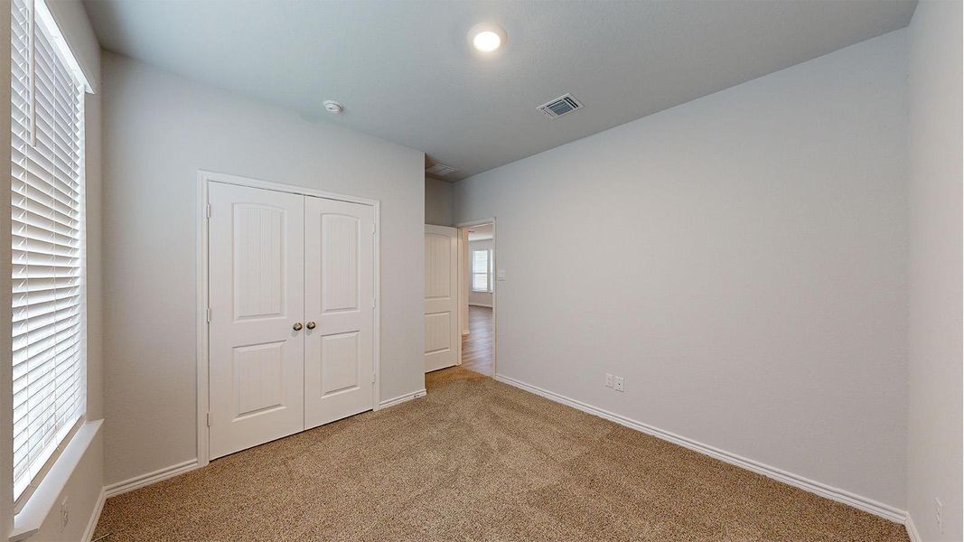 Room featuring light-colored walls and carpeted flooring Room featuring light-colored walls and carpeted flooring