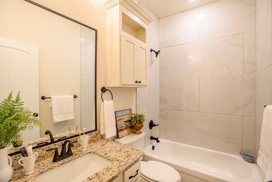 Bathroom featuring vanity and shower / bath combination Bathroom featuring vanity and shower / bath combination