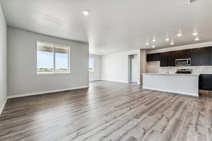 A large empty room with a wood floor.