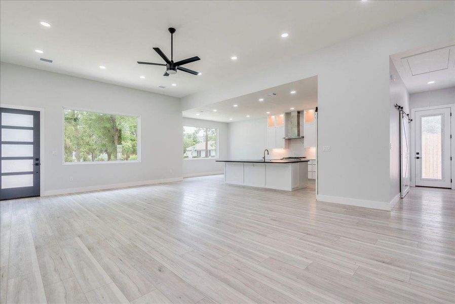 Another view of living room with backdrop view of kitchen and dining area