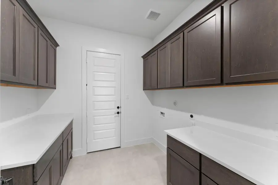 Utility Room with Additional Storage Cabinets, Folding Counter, and Washer and Dryer Connections