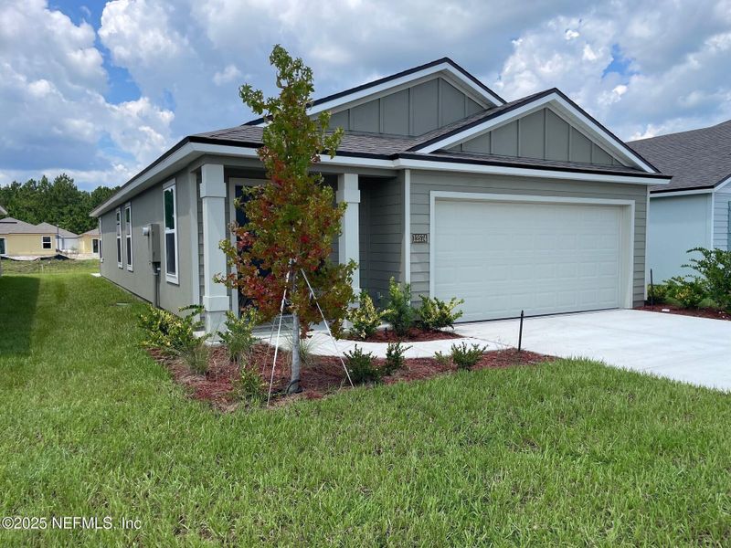 Front exterior of a new home in The Arbors, Jacksonville, FL, highlighting curb appeal (Image 27). Front exterior of a new home in The Arbors, Jacksonville, FL, highlighting curb appeal (Image 27).