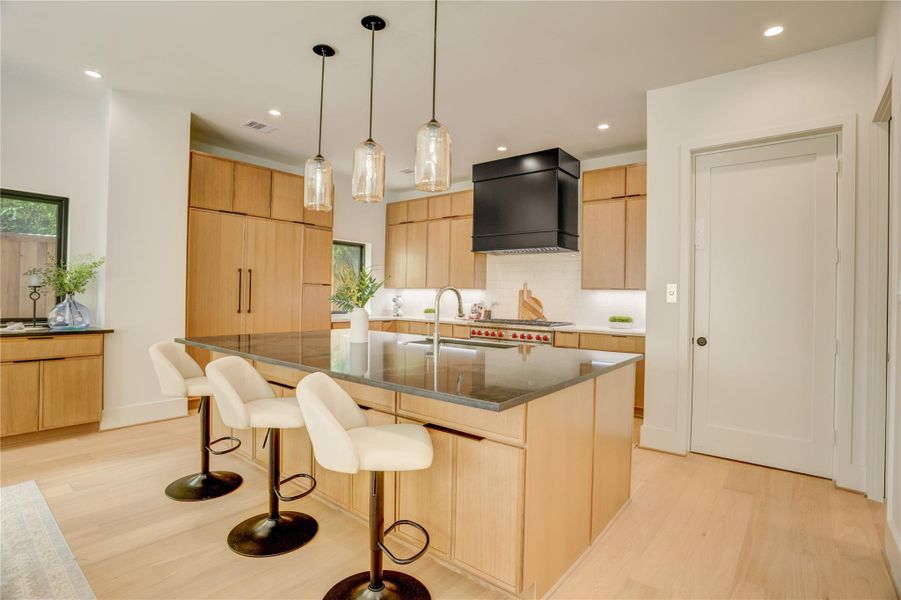 View of the chef's kitchen from the dining room. Fully equipped with SubZero/Wolf appliances, as well as ample counter and cabinet space and amazing natural light.