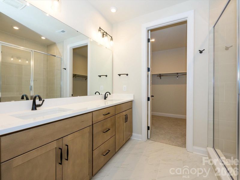 Dual Vanity Bathroom with Warm Brown Cabinets and White Quartz Countertops