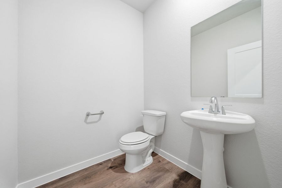 A bathroom with a toilet and sink. A bathroom with a toilet and sink.