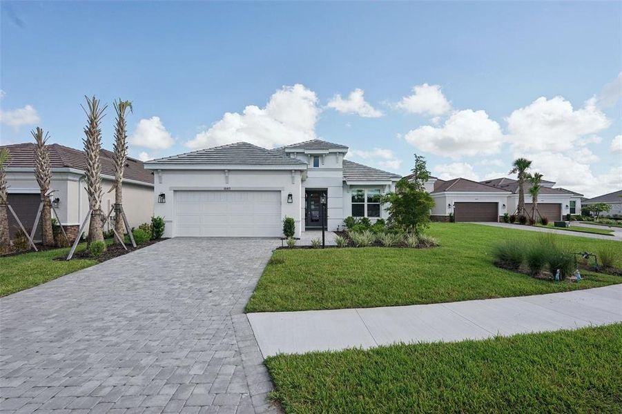 Front exterior of a new home in Esplanade at Azario Lakewood Ranch, Bradenton, FL, highlighting curb appeal (Image 24).