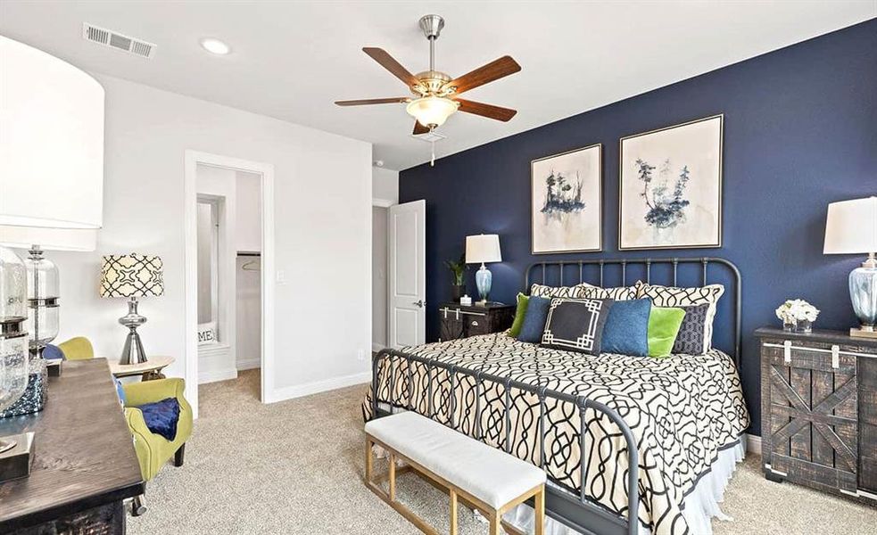 Bedroom with ceiling fan and light colored carpet