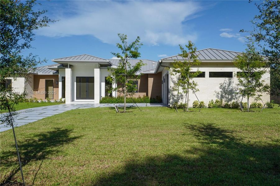 Front exterior of a new home in , Homestead, FL, highlighting curb appeal (Image 45).