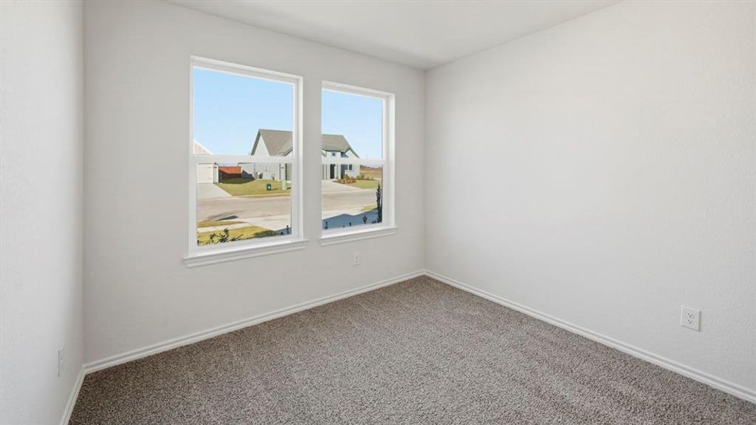 Empty room featuring carpet and baseboards Empty room featuring carpet and baseboards