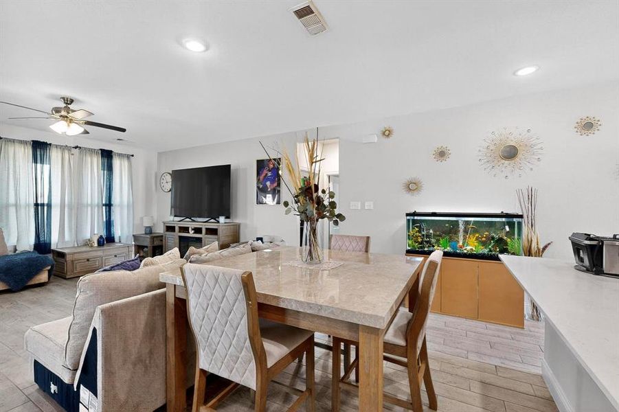 Dining room featuring light wood-style floors, a ceiling fan, and recessed lighting Dining room featuring light wood-style floors, a ceiling fan, and recessed lighting