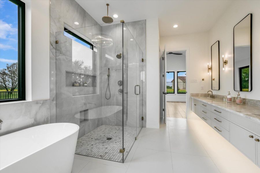 Contemporary bathroom featuring a freestanding tub, glass-enclosed shower with tiled walls and floor, dual vanity with undermount sinks, and floating cabinetry