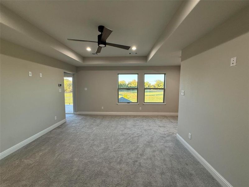 Unfurnished room with a tray ceiling, carpet, recessed lighting, and ceiling fan Unfurnished room with a tray ceiling, carpet, recessed lighting, and ceiling fan