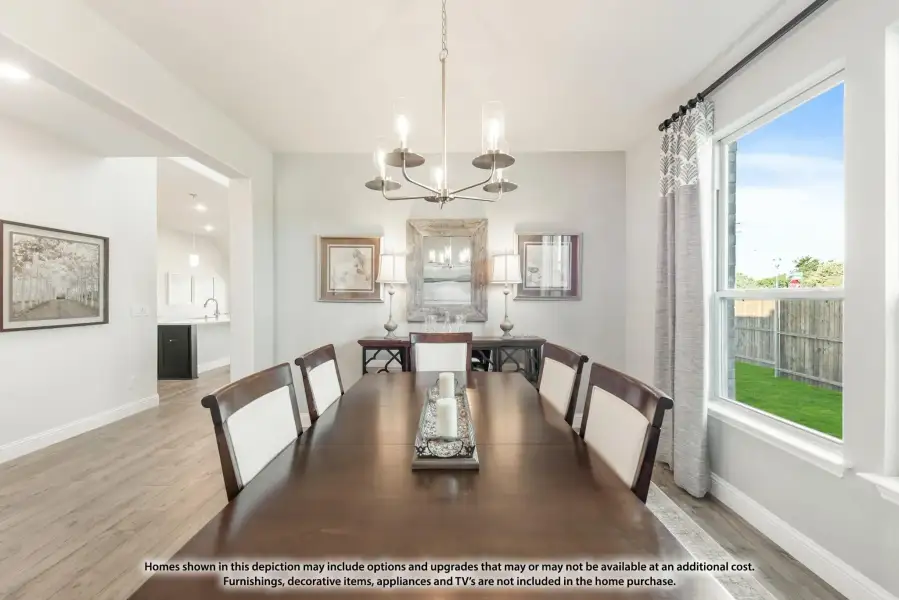 Dining room with dark wood table, eight chairs, chandelier, and large window with backyard view