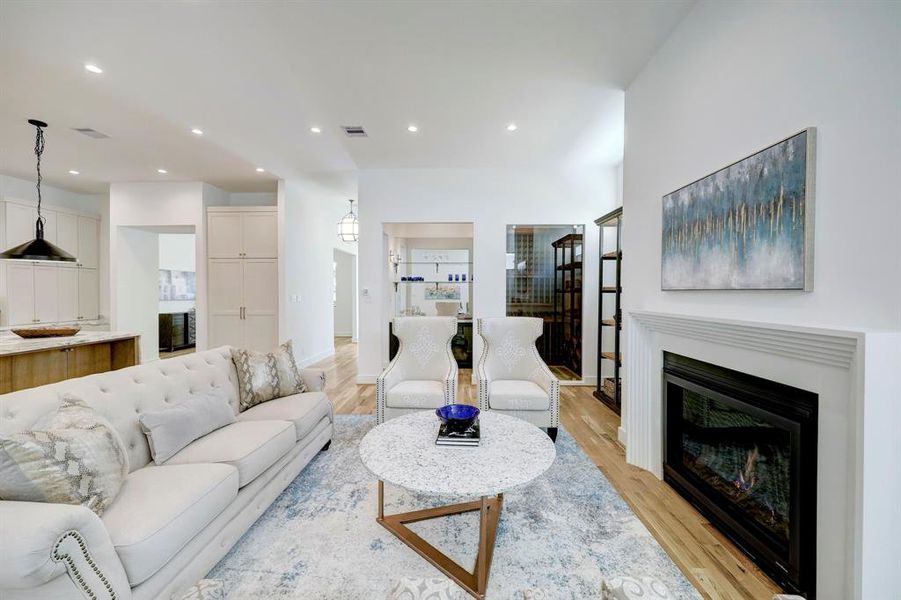 Great room with 11 ft. ceilings and fireplace highlighted by wine room