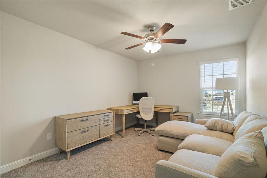 Office space with light carpet and ceiling fan Office space with light carpet and ceiling fan