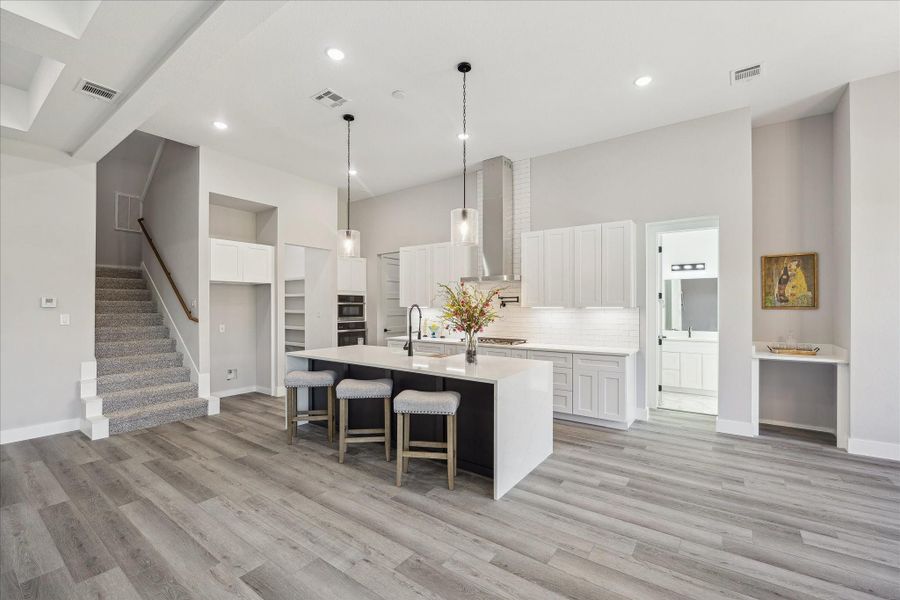 Plenty of Prep Space for the Consummate Chef with a Full Walk In Pantry. Waterfall Center Island and dramatic Rain Water Cylinder Pendants create a enhance a Kitchen that invites the most Consummate Chef. Create your culinary art here!