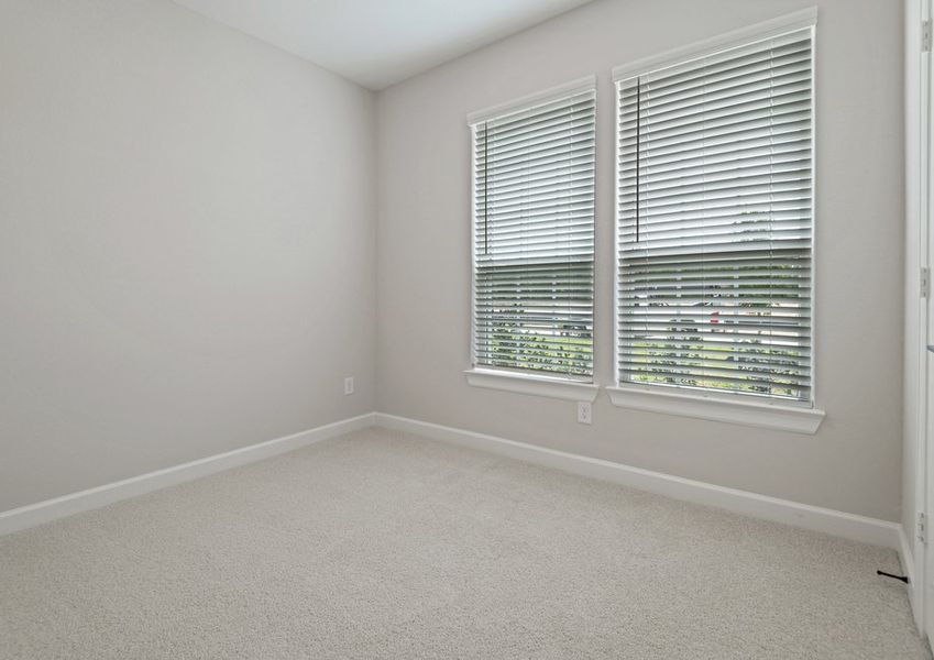 Bedroom with lush carpet flooring Bedroom with lush carpet flooring