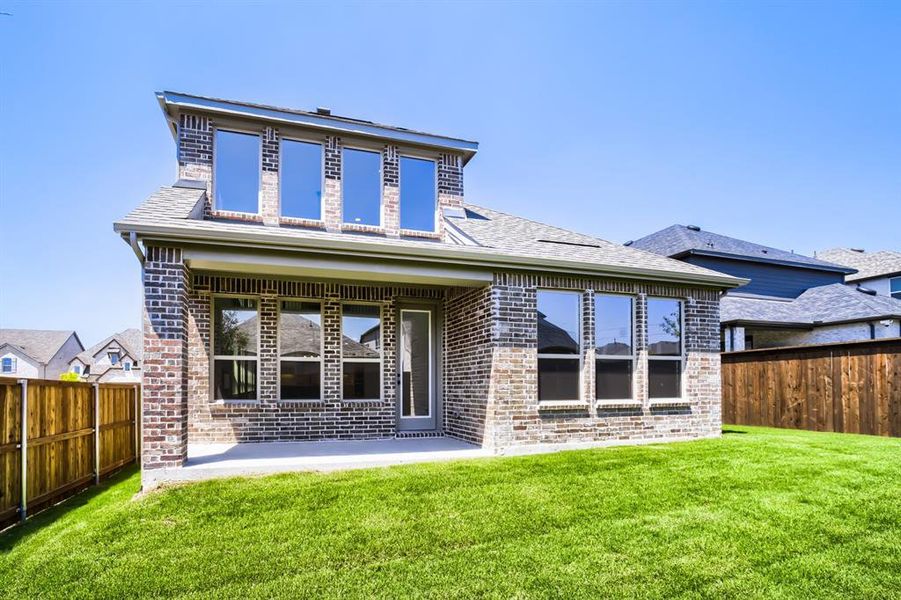 Brick exterior featuring a covered patio with direct access to the backyard
