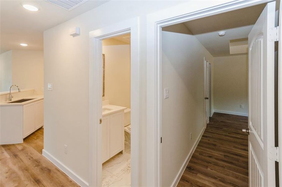 Corridor with sink and hardwood / wood-style flooring