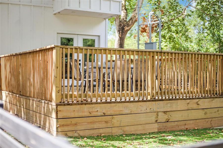 Relax al fresco on this ample wooden deck, perfect for outdoor dining and entertaining.