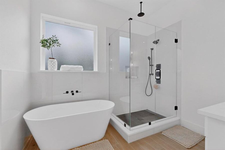 Full bath with a freestanding bath, a shower stall, and vanity