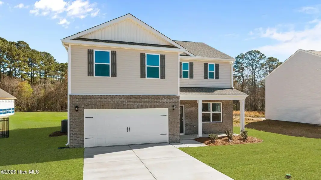 Front exterior of a new home in Villa Grande, Winterville, NC, highlighting curb appeal (Image 2). Front exterior of a new home in Villa Grande, Winterville, NC, highlighting curb appeal (Image 2).