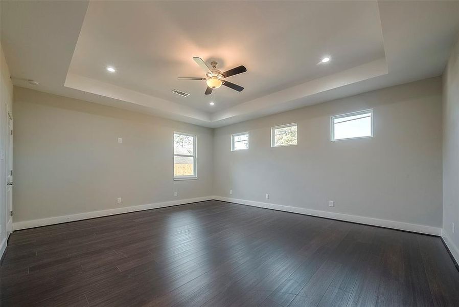 Primary bedroom with vaulted ceilings