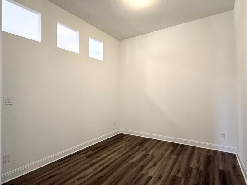 Empty room with dark wood finished floors and baseboards Empty room with dark wood finished floors and baseboards