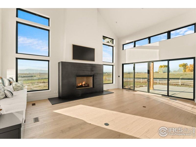 Steel mantel and hearth by Huber Designs accompany the wood burning fireplace (gas available)