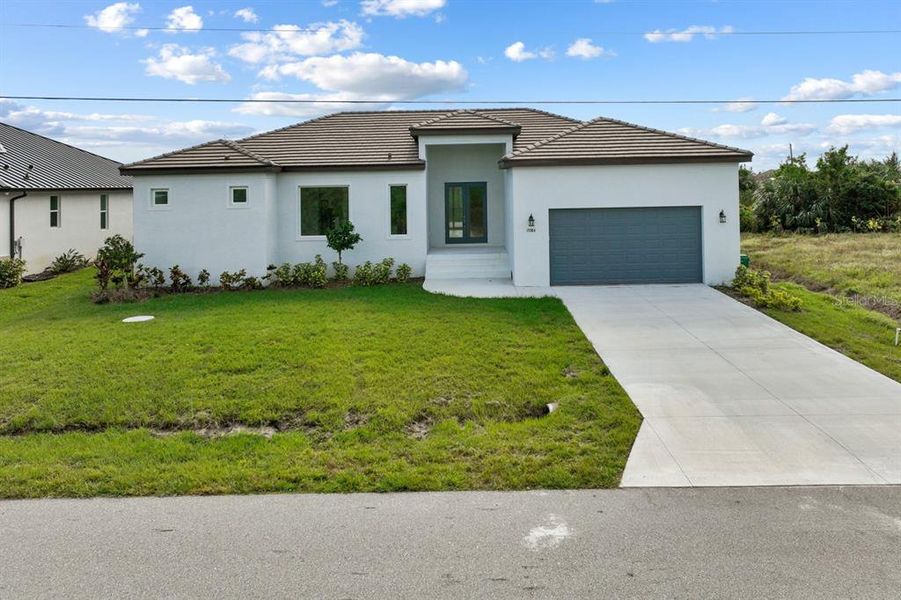Front exterior of a new home in , Port Charlotte, FL, highlighting curb appeal (Image 1). Front exterior of a new home in , Port Charlotte, FL, highlighting curb appeal (Image 1).