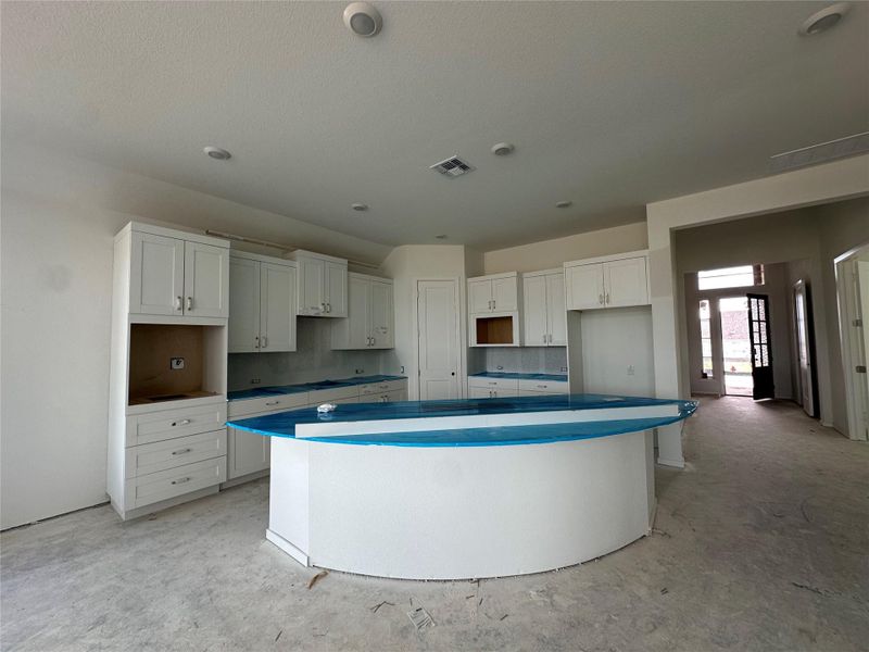 A grand central island anchors this spacious kitchen, ready for culinary creations and lively gatherings. A grand central island anchors this spacious kitchen, ready for culinary creations and lively gatherings.