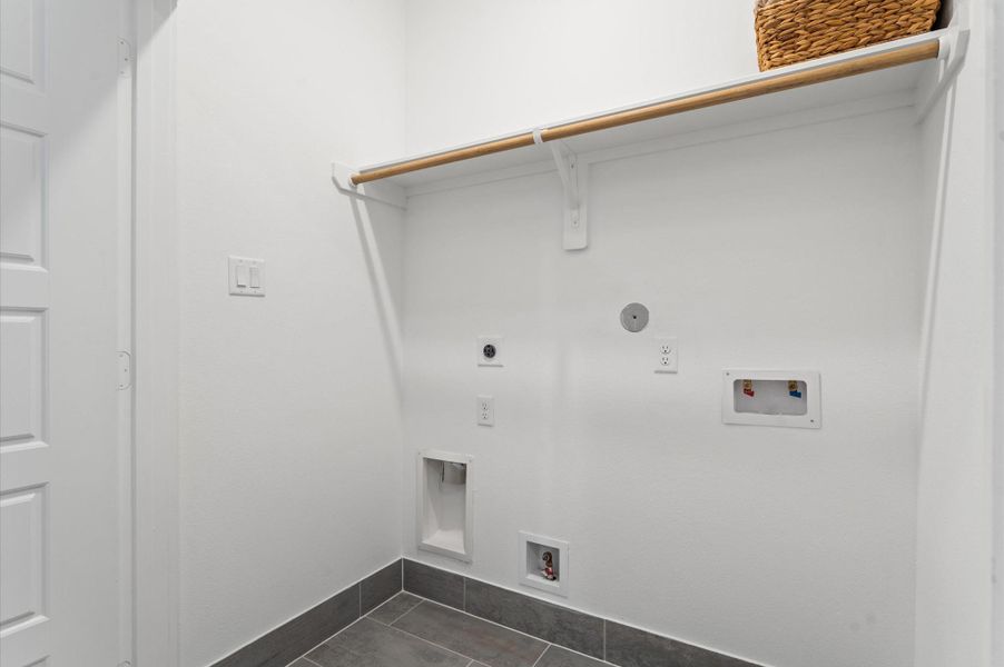 Conveniently located on the second floor, this dedicated laundry area makes everyday chores a breeze. Positioned near the bedrooms for maximum efficiency, it features built-in shelving for supplies and enough space for a full-size washer and dryer. Conveniently located on the second floor, this dedicated laundry area makes everyday chores a breeze. Positioned near the bedrooms for maximum efficiency, it features built-in shelving for supplies and enough space for a full-size washer and dryer.