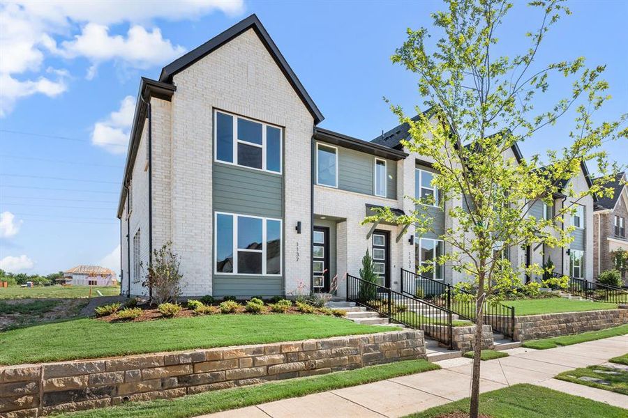 Featuring white brick with a contemporary trim, this dream home offers fantastic curb appeal!